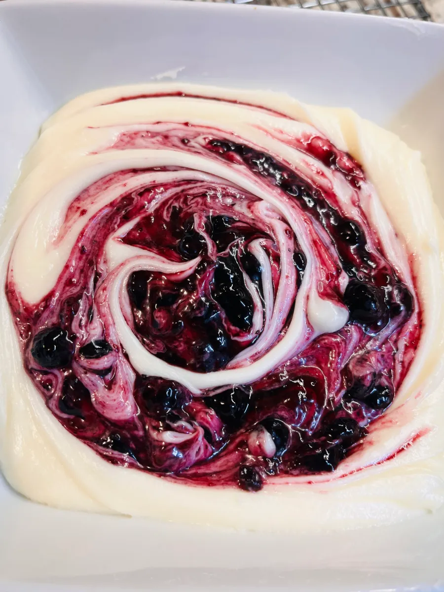 Swirled cream cheese frosting with blueberry preserves