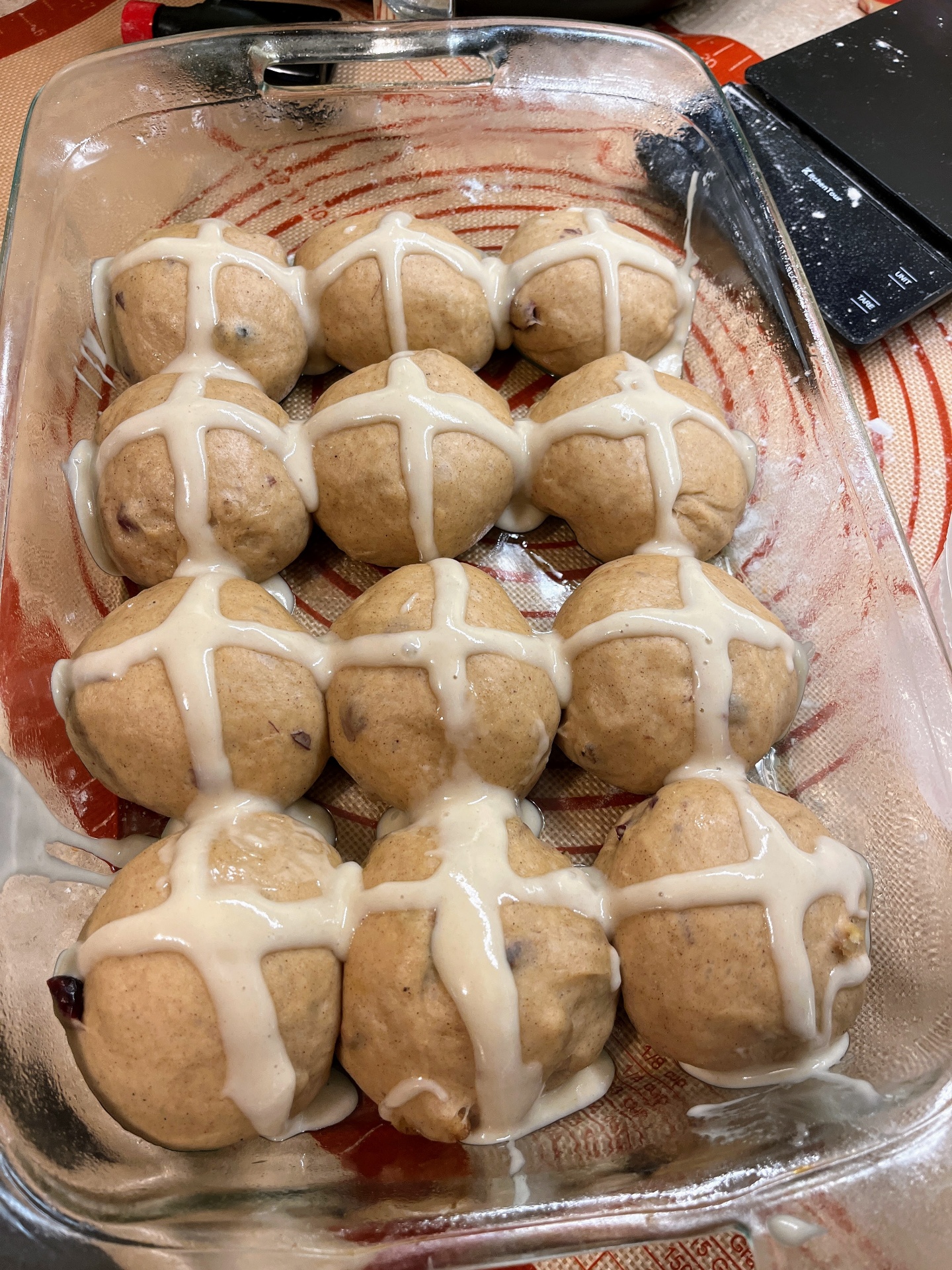 Sourdough hot cross buns with flour paste crosses piped on before baking